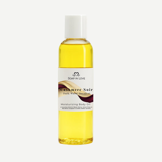 Bottle of Cashmere Noir moisturizing body oil on a white background