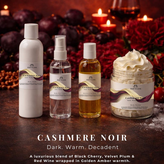 Cashmere Noir skincare products with a warm, dark background featuring candles and fruits.